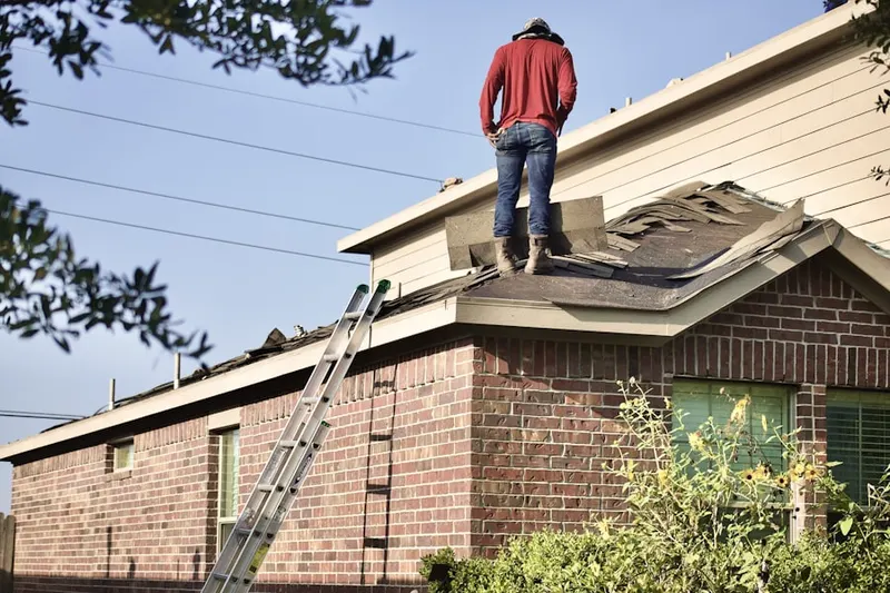 Professional roofer working on a residential roof in Stuck
